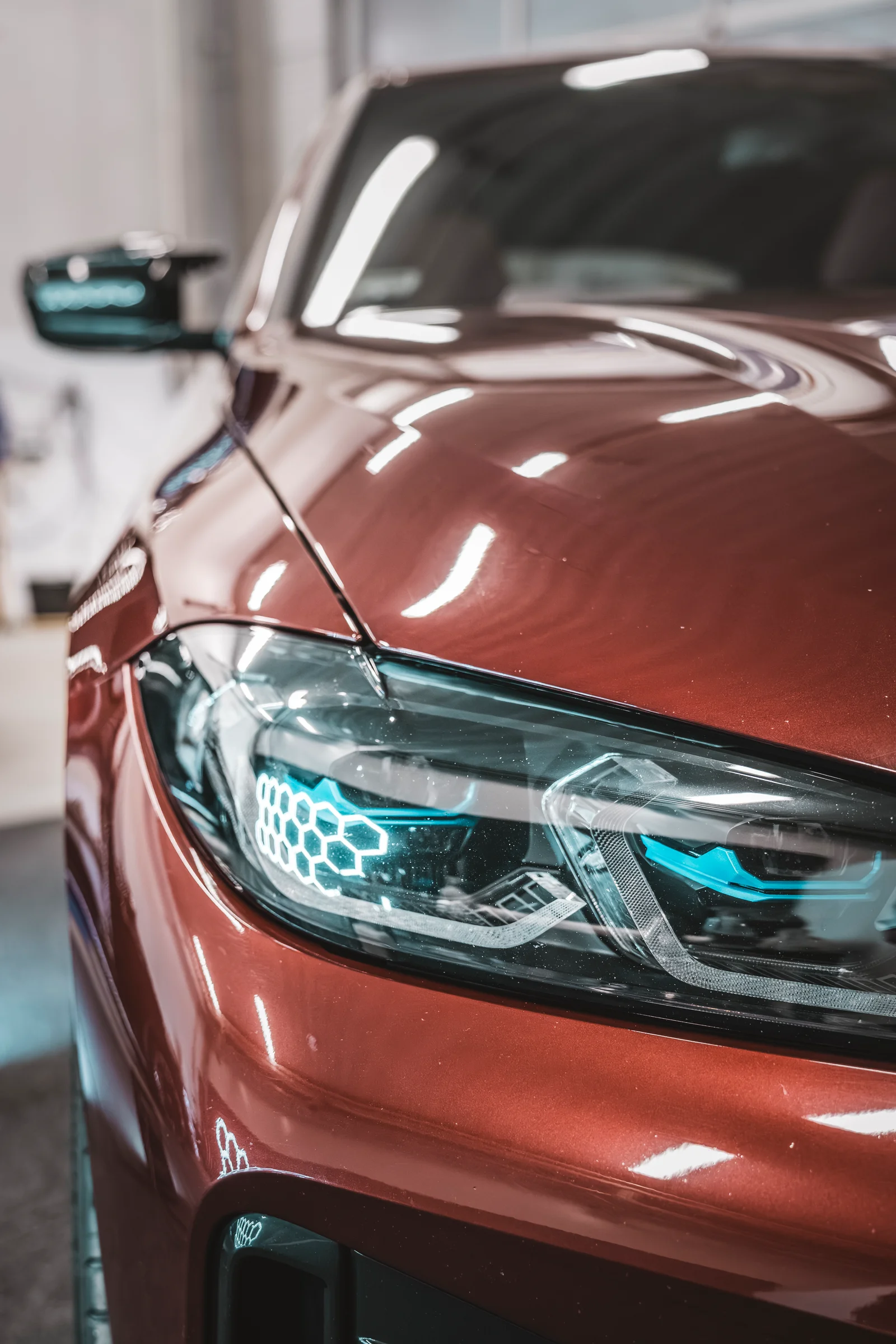 Punaisen BMW:n ajovalo ja kiiltävä etulokasuoja